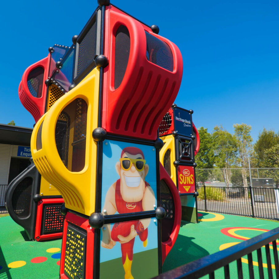 The side of a playground with a caricature of a footy player